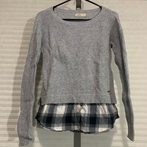 Gray knit sweater with plaid undershirt at bottom
